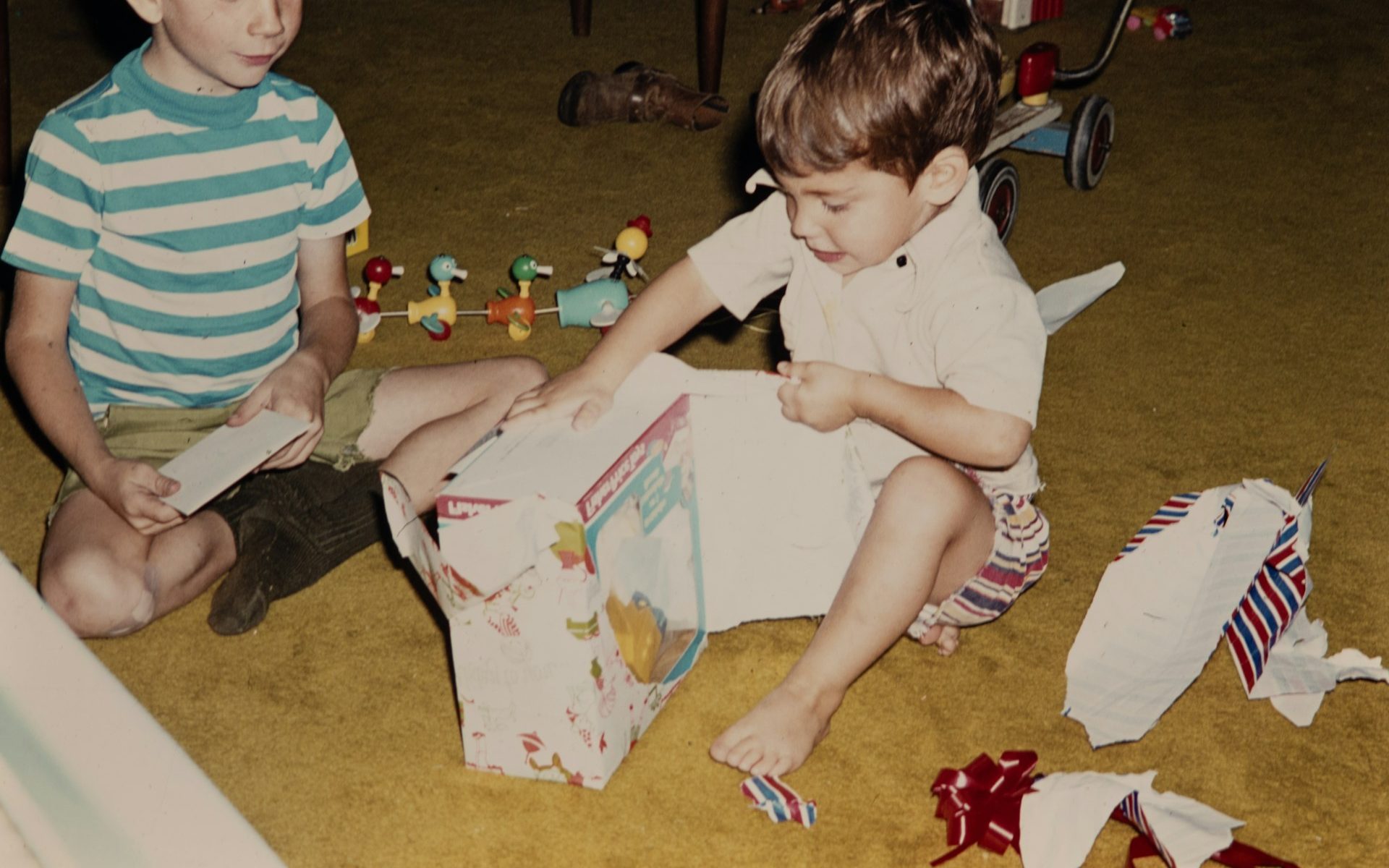 two kids opening a Christmas present